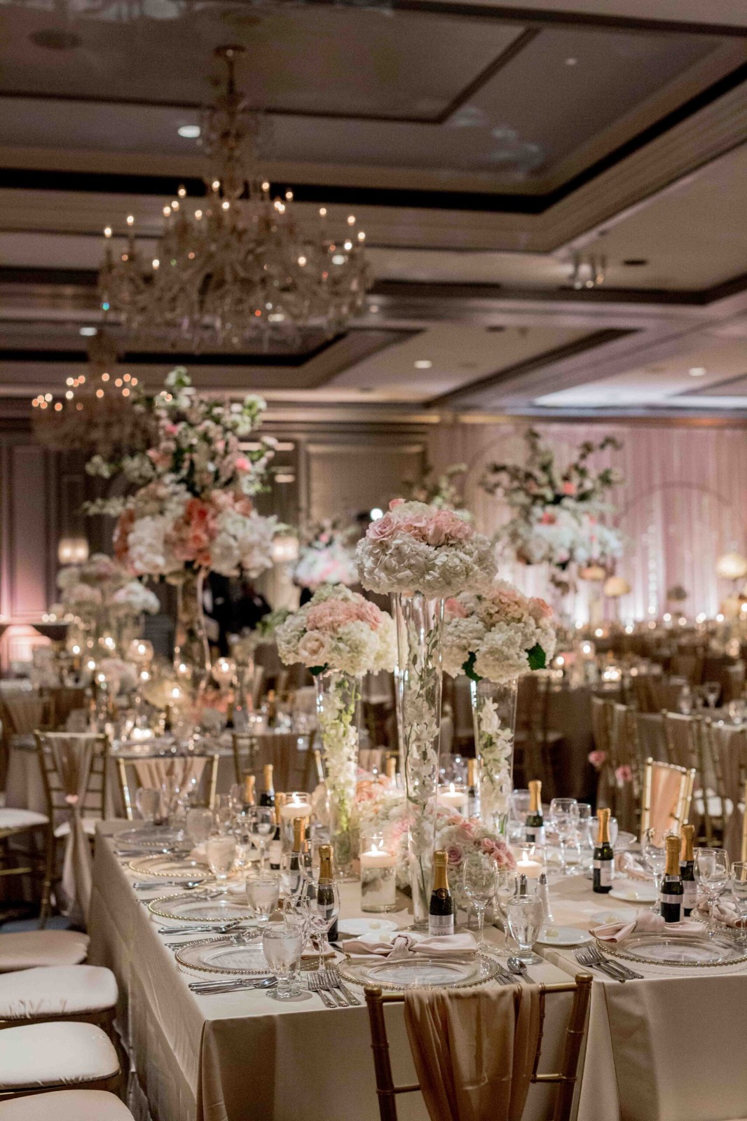 Luxury wedding floral installation in soft candlelight